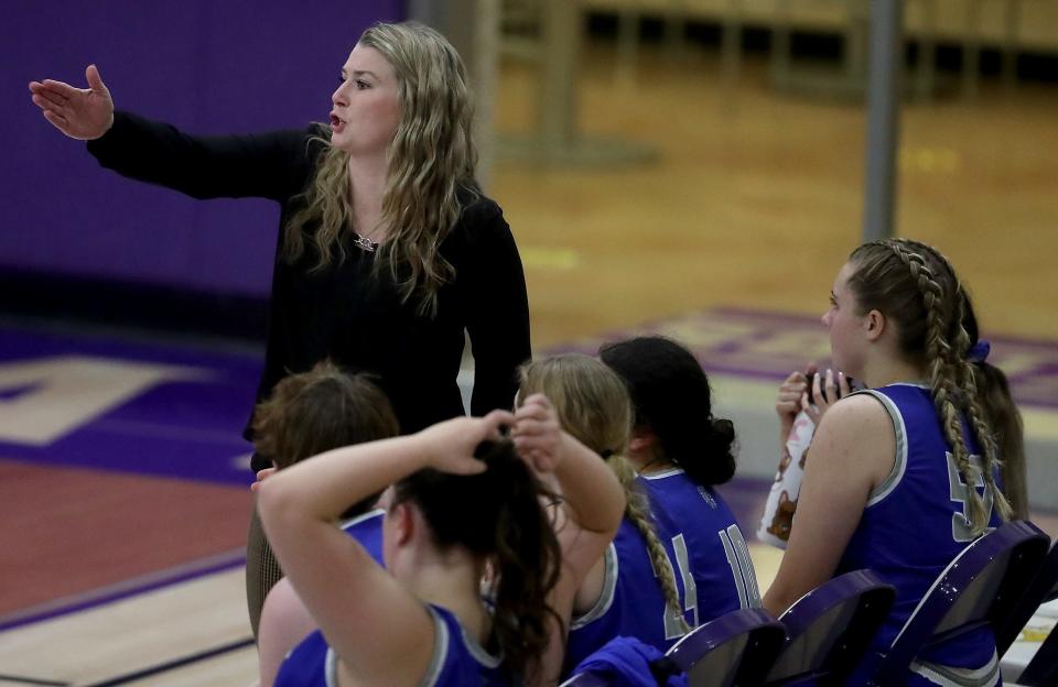 Olympic Trojans head coach Kelsey Callaghan coaches from the sideline during their game against the North Kitsap Vikings in Poulsbo on Tuesday, Dec. 6, 2022.