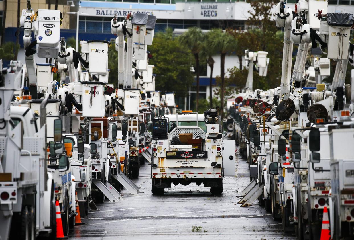 Duke Energy trucks are staged the parking lot at Tropicana Field