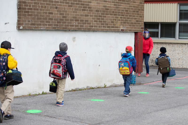 Green dots are placed in a schoolyard as schools reopen outside the greater Montreal region in Saint-Jean-sur-Richelieu