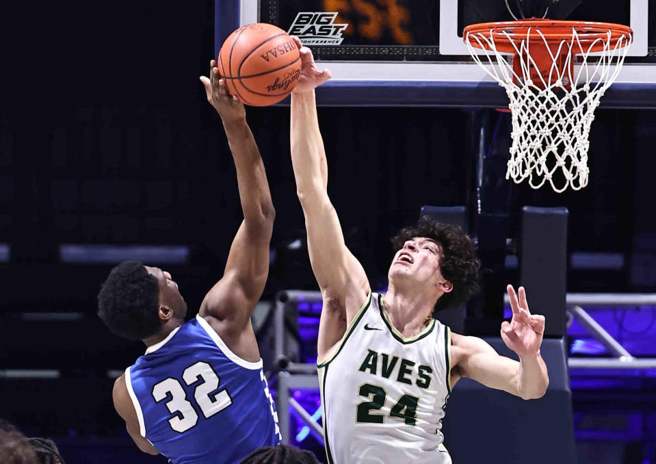 Sycamore center Raleigh Burgess (24) blocks a shot by Hamilton's Mason King (32) during their district final Sunday, March 10, 2024.