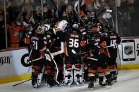 Anaheim Ducks players celebrate after left wing Matt Beleskey (not pictured) scored the game-winning goal against the Chicago Blackhawks during the overtime period in game five of the Western Conference Final of the 2015 Stanley Cup Playoffs at Honda Center. Mandatory Credit: Richard Mackson-USA TODAY Sports