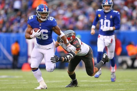 New York Giants running back Saquon Barkley (26) rushes past Tampa Bay Buccaneers cornerback Brent Grimes (24) in front of quarterback Eli Manning (10) during the second half at MetLife Stadium - Credit: Vincent Carchietta/USA TODAY