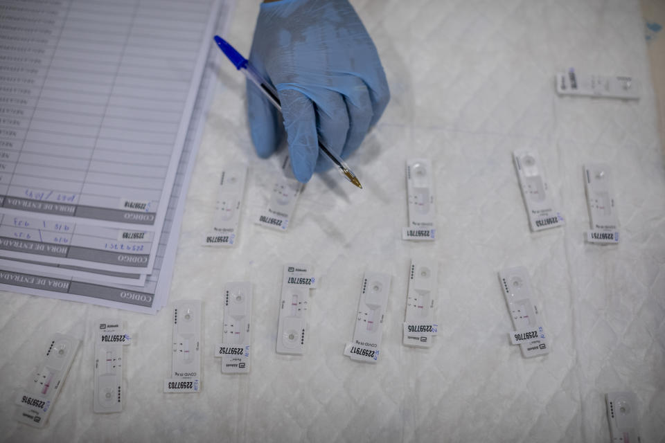 A Madrid Emergency Service (SUMMA) health worker conducts a rapid antigen test for COVID-19 in the southern neighbourhood of Vallecas in Madrid, Spain, Tuesday, Sept. 29, 2020. In Spain, nearly 36,000 have died and more than 1.2 million have contracted the virus, although the real infection tally could be at least three times higher. (AP Photo/Bernat Armangue)