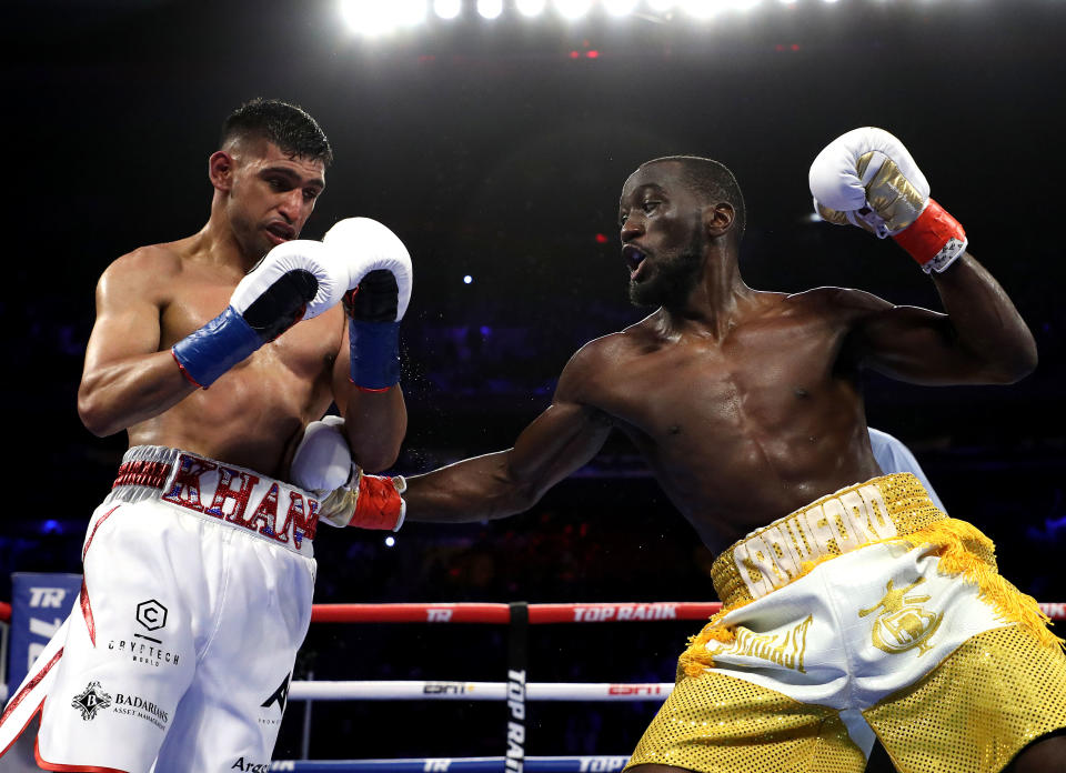 NEW YORK, NEW YORK - APRIL 20:  Terence Crawford punches Amir Khan  during their WBO welterweight title fight at Madison Square Garden on April 20, 2019 in New York City. (Photo by Al Bello/Getty Images)