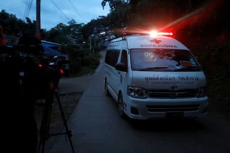 Journalists film an ambulance believed to be carrying rescued schoolboys as it travels to a military helipad near Tham Luang cave complex in the northern province of Chiang Rai, Thailand, July 8, 2018. REUTERS/Soe Zeya Tun