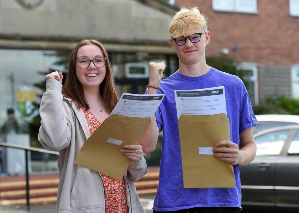 Abi Trainor and Ben Aiken, pupils at Sullivan Upper School in Holywood, Co Down, celebrate after receiving their GCSE results (Oliver McVeigh/PA) (PA Wire)