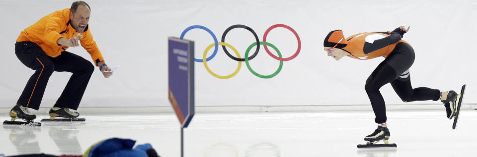 Coach Gerard Kemkers urges on Ireen Wust of the Netherlands during the women's 3,000-meter speedskating race at the Adler Arena Skating Center during the 2014 Winter Olympics, Sunday, Feb. 9, 2014, in Sochi, Russia. Wust won the gold.