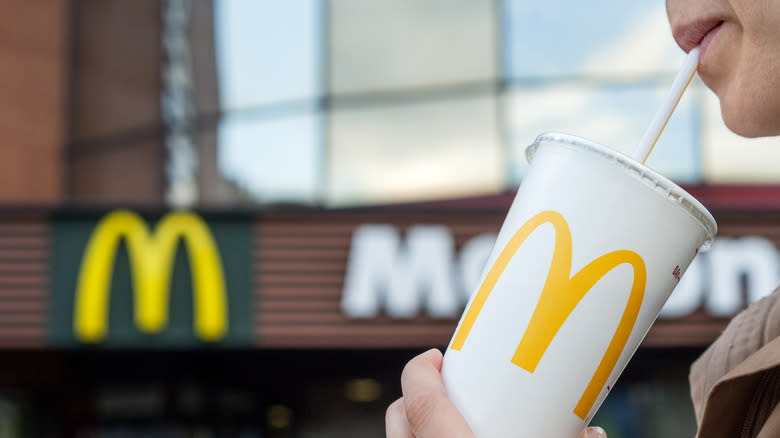 person drinking from Mcdonald's cup