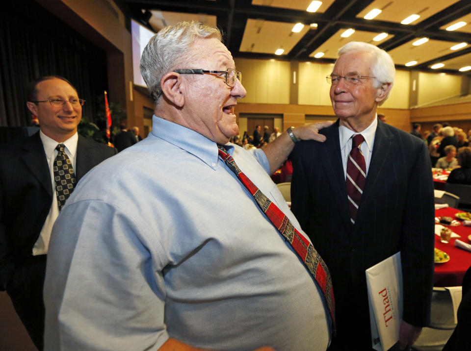 This photo taken Feb. 20, 2014 shows Sen. Thad Cochran, R-Miss., right, listens as Ronnie Silence recalls his years as a student at the same elementary school where the senator went a few years before prior to speaking at Pearl's Chamber of Commerce Awards Banquet in Pearl, Miss. Thad Cochran is engaged in his toughest campaign in a generation. The former Appropriations Committee chairman faces a June 3 primary challenge from a two-term state lawmaker. Chris McDaniel riles up tea party voters by denouncing big federal spending and portraying the 76-year-old incumbent as a Washington insider who’s lost touch with folks back home. (AP Photo/Rogelio V. Solis)