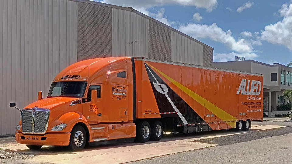 One of Brandon Transfer & Storage's moving trucks sits outside a building