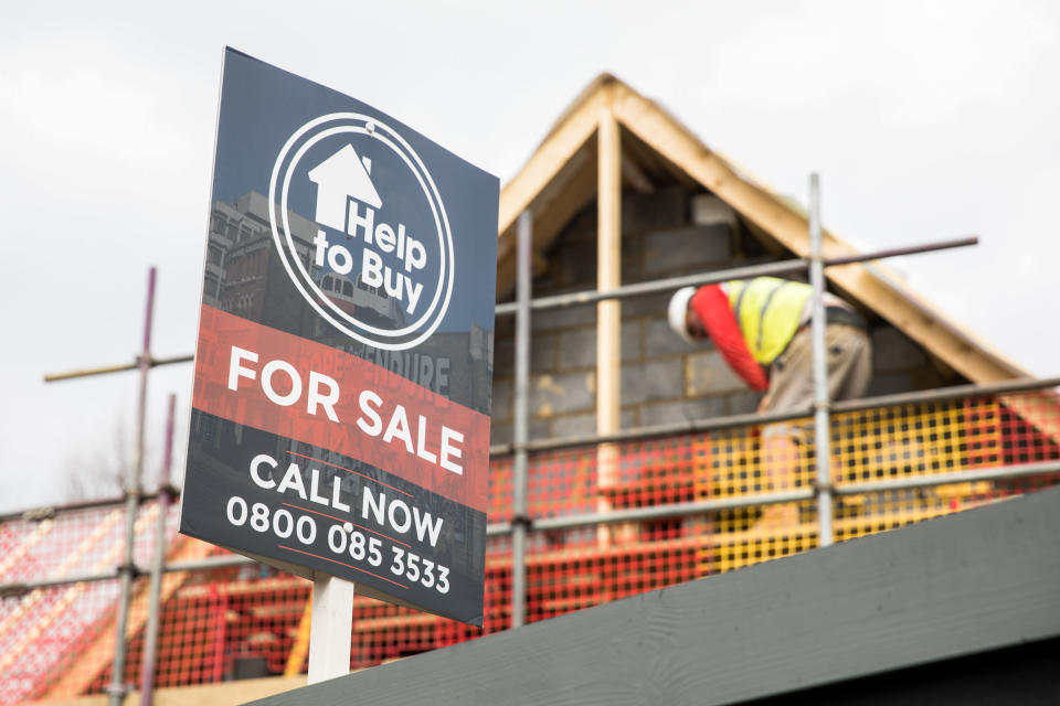 A sign advertising a property for sale under the governments Help To Buy scheme stands next to a building site in London, U.K. on Tuesday, March 26, 2019. With Britain's future outside of the EU still as unclear as ever, the London property market is taking the biggest hit. Photographer: Chris Ratcliffe/Bloomberg via Getty Images