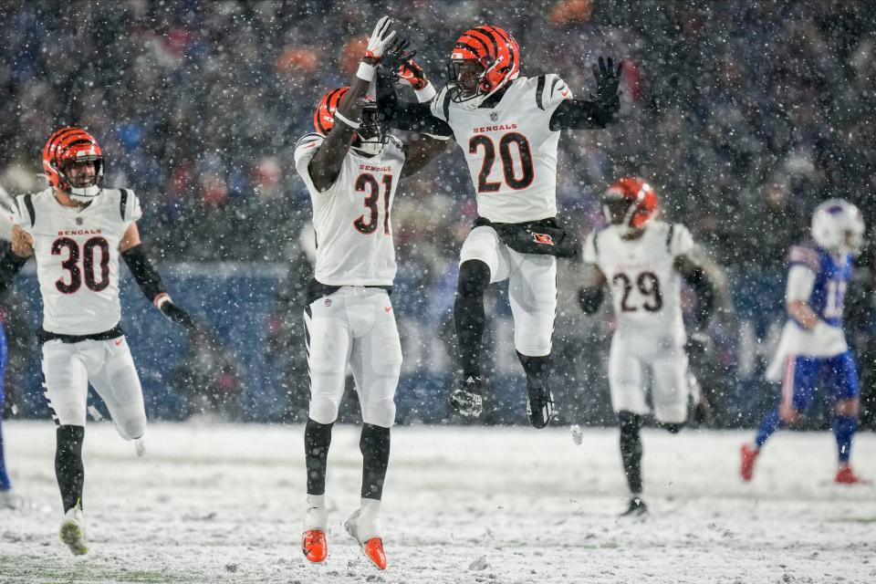 Cincinnati Bengals safety Michael Thomas (31) and Cincinnati Bengals cornerback Eli Apple (20) react after a defensive play against the Buffalo Bills during the fourth quarter of an NFL division round football game, Sunday, Jan. 22, 2023, in Orchard Park, N.Y. (AP Photo/Seth Wenig)