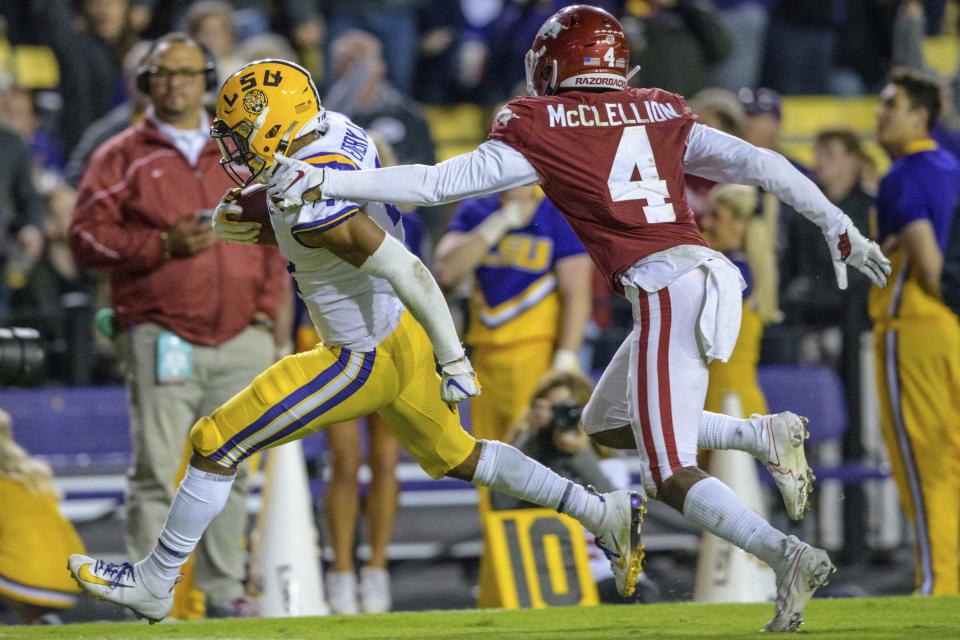 LSU running back John Emery Jr. (4) runs for a touchdown as Arkansas defensive back Jarques McClellion (4) pursues during the second half of an NCAA college football game in Baton Rouge, La., Saturday, Nov. 23, 2019. (AP Photo/Matthew Hinton)