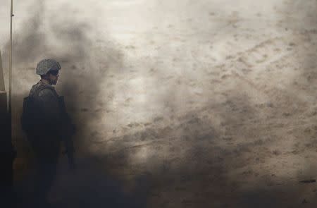 A NATO soldier attends a NATO military exercise at Raposa beach, near Setubal, Portugal October 20, 2015. REUTERS/Rafael Marchante