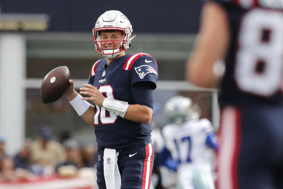 New England Patriots quarterback Mac Jones (10) smiles while warming up prior to an NFL football game against the Dallas Cowboys, Sunday, Oct. 17, 2021, in Foxborough, Mass. (AP Photo/Michael Dwyer)
