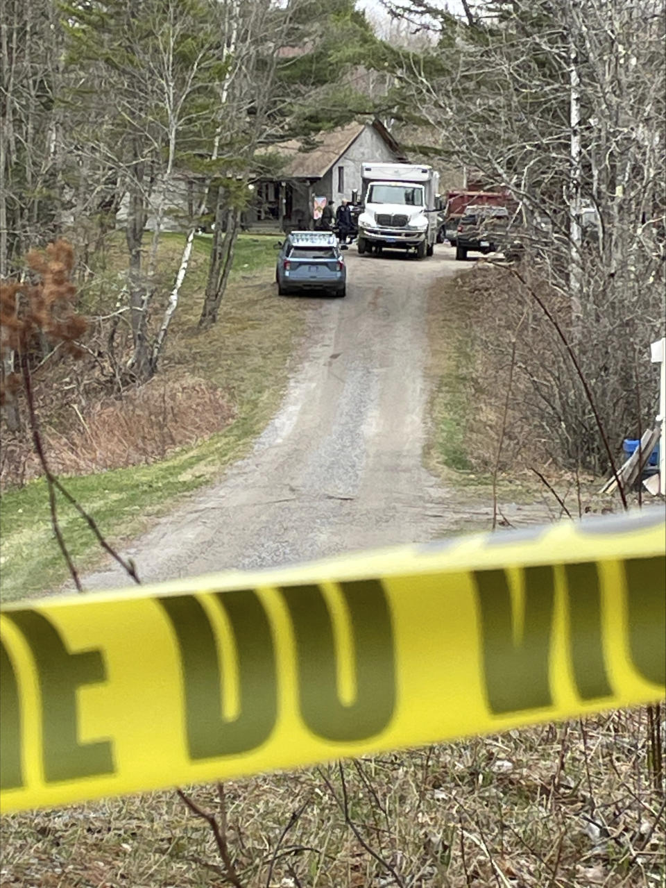 Law enforcement personnel work at a crime scene in Bowdoin, Maine, Wednesday, April 19, 2023. A Maine man who police say killed four people in a home and then shot three others randomly on a busy highway had been released days earlier from prison, a state official said Wednesday. (AP Photo/Rodrique Ngowi)