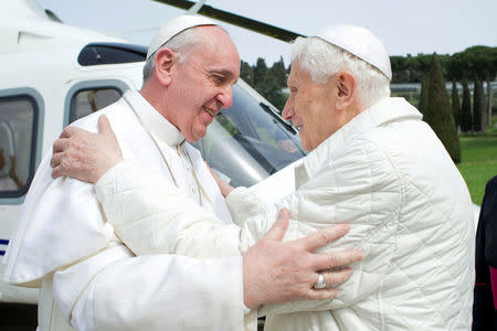 FILE PHOTO : Pope Francis (L) embraces Pope Emeritus Benedict XVI as he arrives at the Castel Gandolfo summer residence March 23, 2013. Osservatore Romano/Handout via Reuters ATTENTION EDITORS - THIS IMAGE WAS PROVIDED BY A THIRD PARTY.