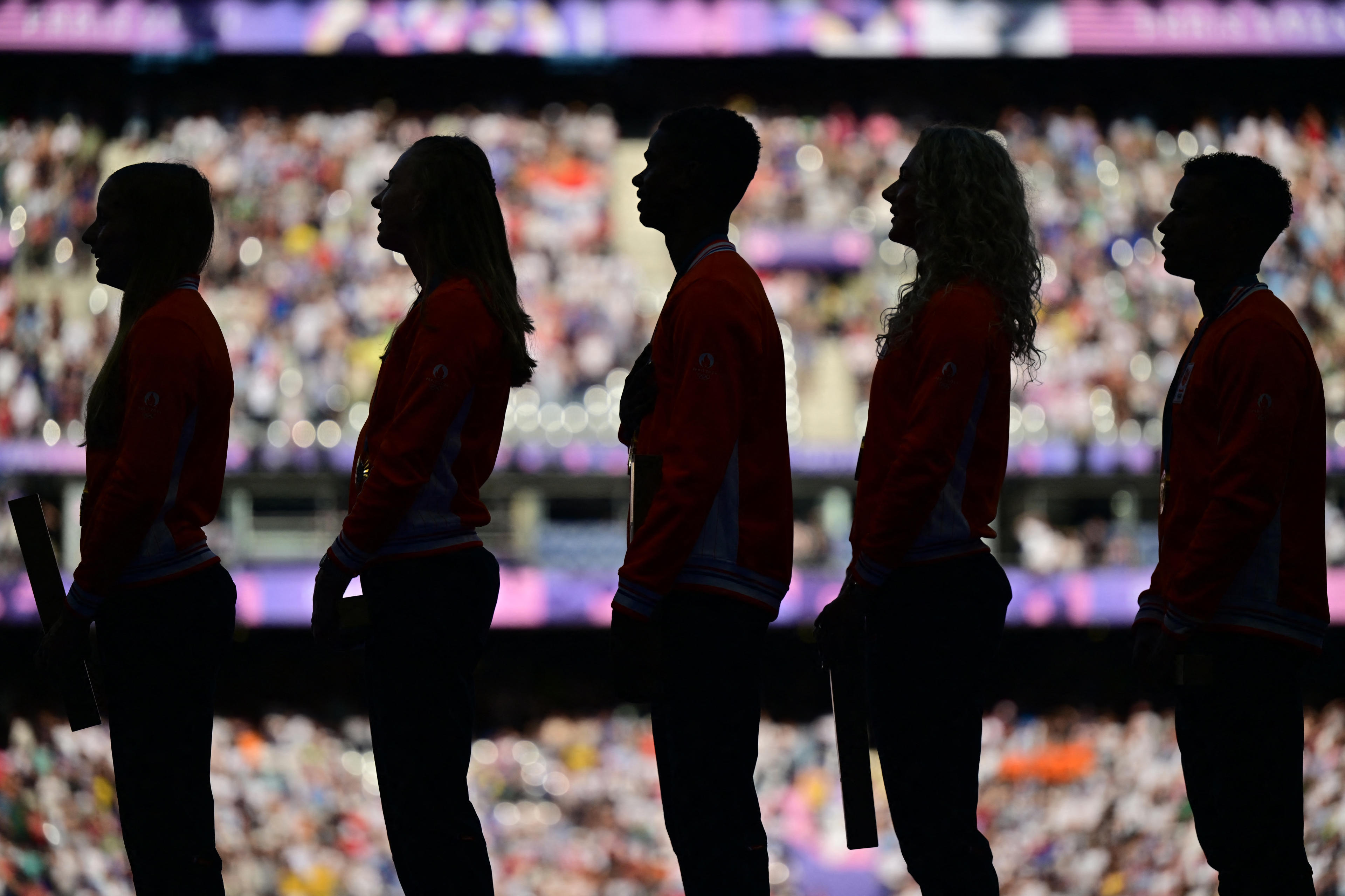 Netherlands gold medalists Isaya Klein Ikkink, Eugene Omalla, Lieke Klaver, Femke Bol and Cathelijn Peeters stand on the podium after competing in the mixed's 4x400m relay. (Photo by Martin Bernetti /AFP)