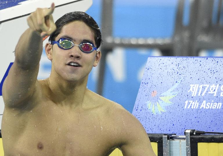 Joseph Schooling celebrates winning the Asian Games men&#39;s 100m butterfly in Incheon on September 24, 2014