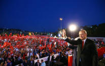 <p>Turkish President Tayyip Erdogan and his wife Emine Erdogan greet their supporters as they arrive for a ceremony marking the first anniversary of the attempted coup at the Bosphorus Bridge in Istanbul, Turkey July 15, 2017. (Photo: Kayhan Ozer/Presidential Palace/Handout via Reuters) </p>