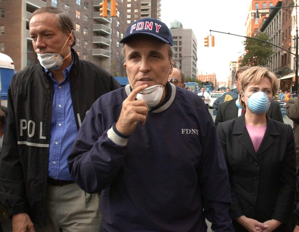 New York Gov. George Pataki, left, New York City Mayor Rudy Giuliani, center, and Sen. Hillary Rodham Clinton, D-N.Y., tour the site of the World Trade Center disaster, in this Sept. 12, 2001, file photo. (Robert F. Bukaty/AP)