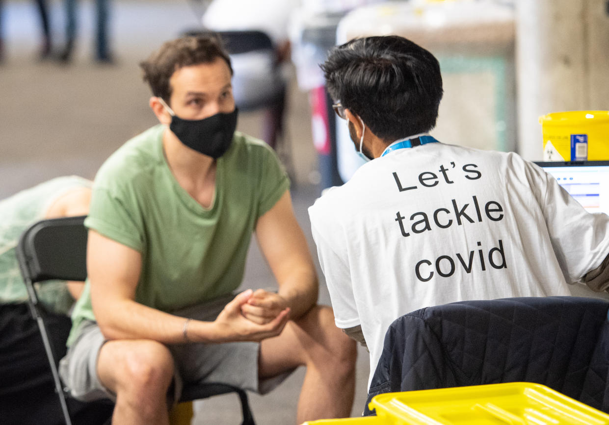 A man receives a coronavirus vaccination at Twickenham rugby stadium, south-west London, where up to 15,000 doses are ready to be administered at the walk-in centre which has been set up for residents of north-west London in response to an increase in the number of cases of coronavirus in the area. Picture date: Monday May 31, 2021.