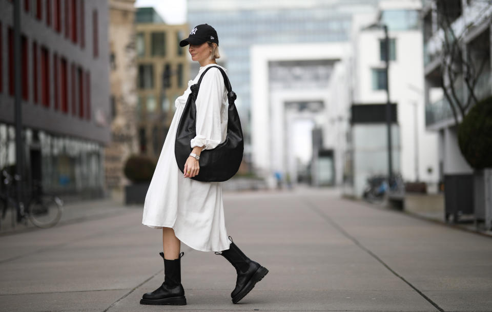 COLOGNE, GERMANY - MARCH 07: Kathrin Bommann (viva_la_wow) wearing Pixie Shop dress, Bottega Veneta boots, Frankie Shop bag and, New Era cap on March 07, 2020 in Cologne, Germany. (Photo by Jeremy Moeller/Getty Images)