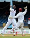 West Indies cricketer Darren Sammy (L) and Carlton Baugh (R) celebrate the wicket of Australian batsman Michael Clarke during the final day of the second-of-three Test matches between Australia and West Indies April19, 2012 at Queen's Park Oval in Port of Spain, Trinidad.