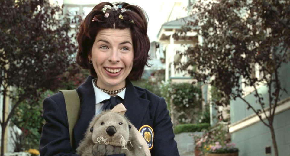 A young Heather Matarazzo holding a stuffed animal