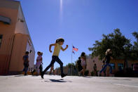 Whittier Elementary School students enjoy recess, Tuesday, Oct. 18, 2022 in Mesa, Ariz. Like many school districts across the country, Mesa has a teacher shortage due in part due to low morale and declining interest in the profession. Five years ago, Mesa allowed Whittier to participate in a program making it easier for the district to fill staffing gaps, grant educators greater agency over their work and make teaching a more attractive career. The model, known as team teaching, allows teachers to combine classes and grades rotating between big group instruction, one-on-one interventions, small study groups or whatever the team agrees is a priority each day. (AP Photo/Matt York)