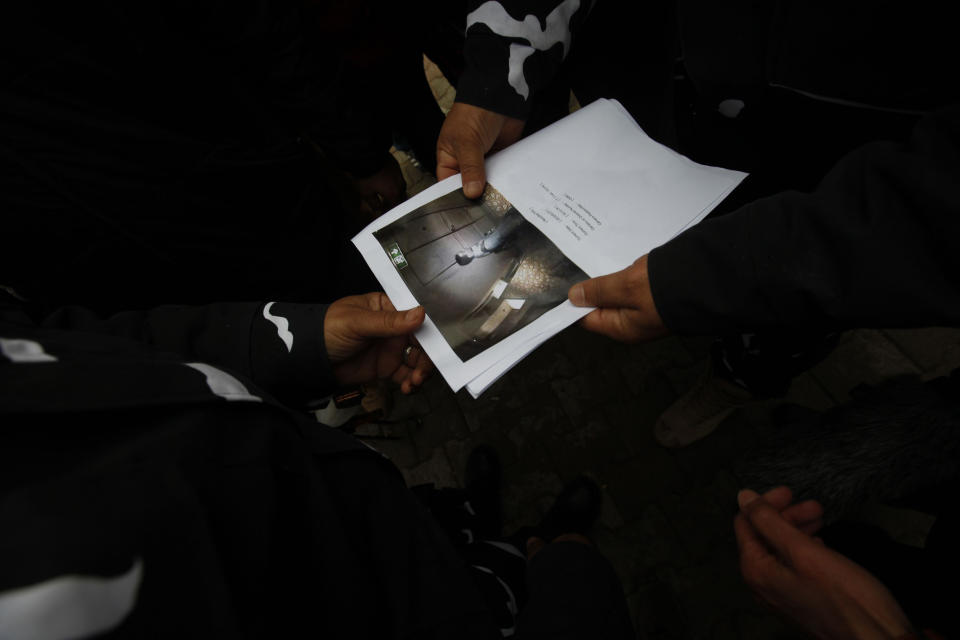 Security forces show a picture of one of the gunmen who attacked Corinthia hotel, caught on the hotel's security cameras, in Tripoli