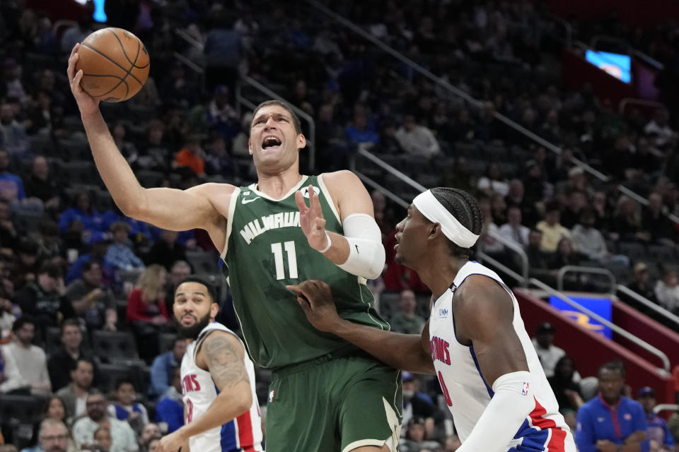 Milwaukee Bucks center Brook Lopez (11) is defended by Detroit Pistons center Jalen Duren (0) during the first half of an NBA basketball game, Monday, March 27, 2023, in Detroit. (AP Photo/Carlos Osorio)