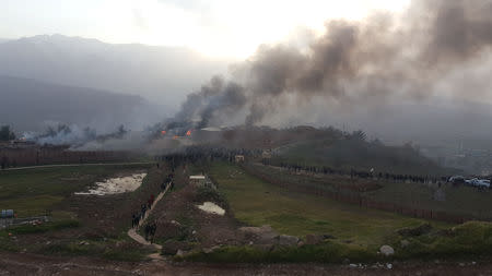 Smoke rises from a Turkish military camp after protesters stormed near Dohuk, Iraq January 26, 2019. REUTERS/Stringer