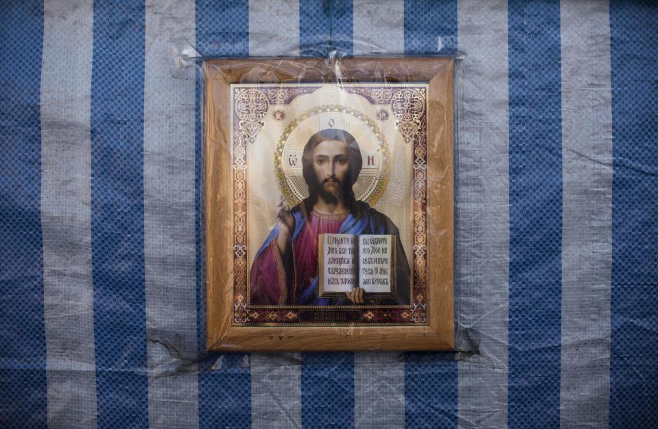 An icon depicting Jesus Christ is affixed to a tent where religious services are held in Kiev's Independence Square, Ukraine, Sunday, March 9, 2014. (AP Photo/David Azia)