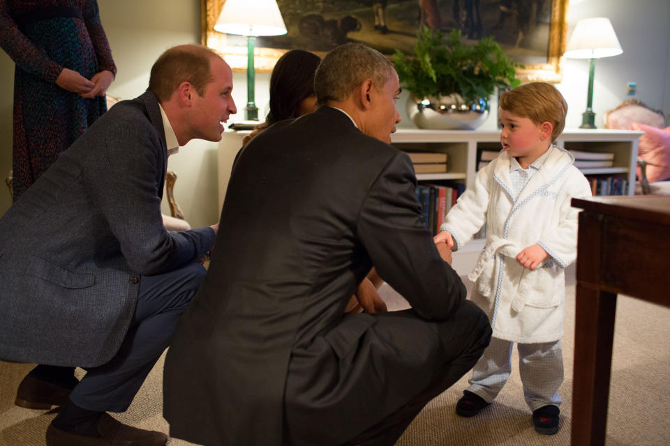 In this 2016 file photo, President Barack Obama shakes hands with Prince George at Kensington Palace as Prince William looks on. (Photo: The White House via Getty Images)