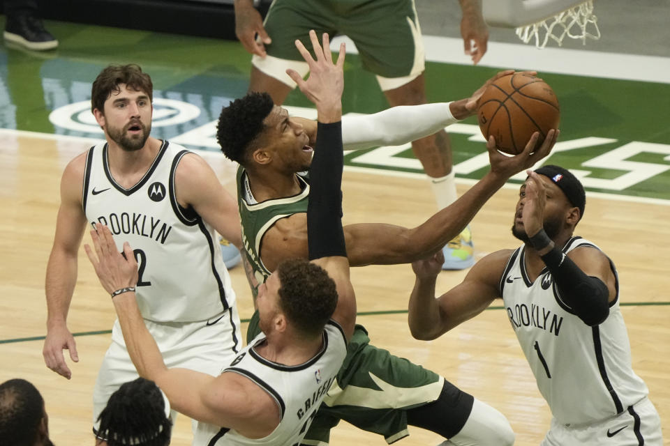 Milwaukee Bucks' Giannis Antetokounmpo shoots past Brooklyn Nets' Bruce Brown and Blake Griffin during the first half of Game 3 of the NBA Eastern Conference basketball semifinals game Thursday, June 10, 2021, in Milwaukee. (AP Photo/Morry Gash)