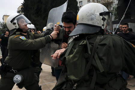 Greek Communist Party supporters clash with police as they try to bring down a statue of former U.S. President Harry Truman during a demonstration against air strikes on Syria by the United States, Britain and France, in Athens, Greece, April 16, 2018. REUTERS/Alkis Konstantinidis