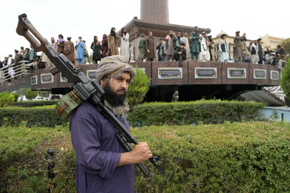 A Taliban fighter holds his weapon during celebrations one year after the Taliban seized the Afghan capital, Kabul, in front of the U.S. Embassy in Kabul, Afghanistan, Monday, Aug. 15, 2022. The Taliban marked the first-year anniversary of their takeover after the country's western-backed government fled and the Afghan military crumbled in the face of the insurgents' advance. (AP Photo/Ebrahim Noroozi)