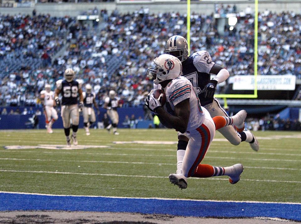 Dolphins receiver Chris Chambers catches one of three touchdown passes against the Cowboys on Thanksgiving Day 2003.