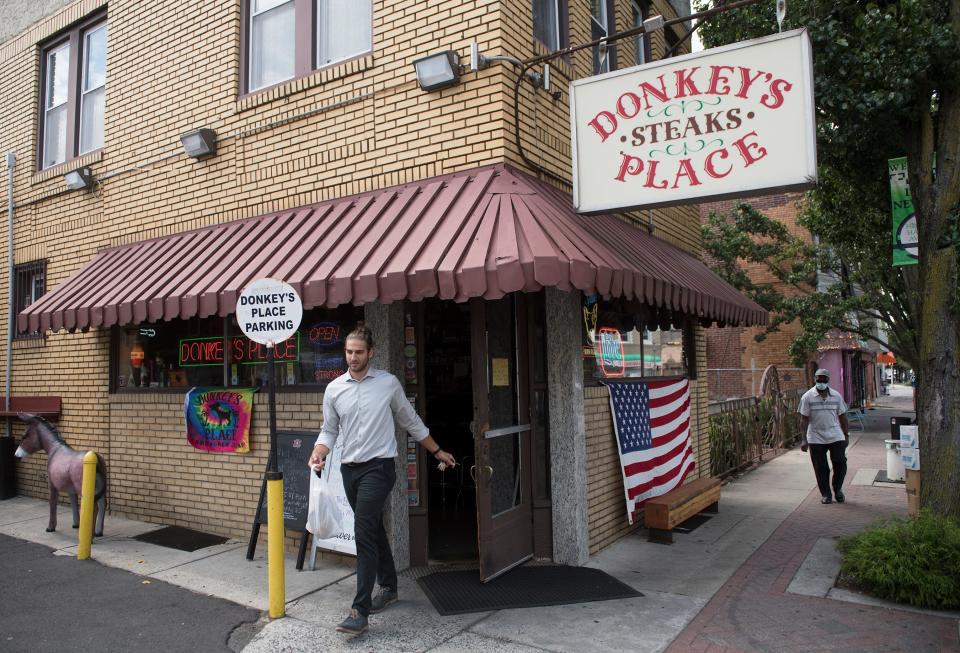 A customer exits Donkey's Place in Camden.