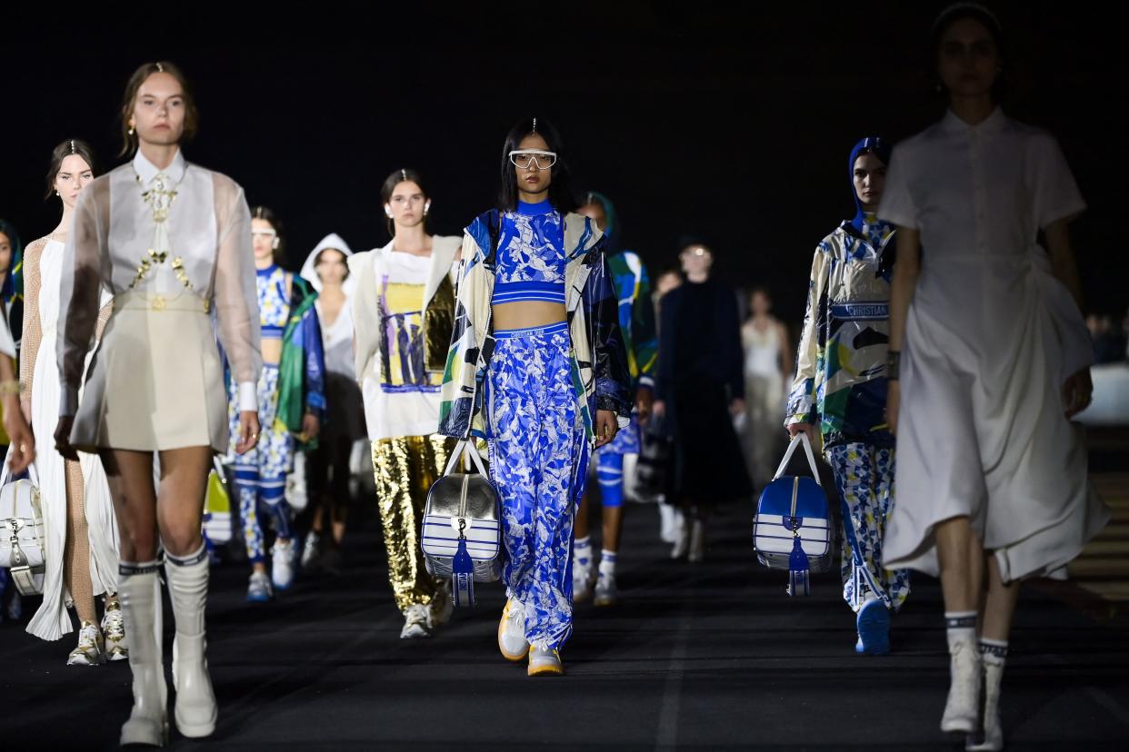 TOPSHOT - Models present creations for Dior during the 2022 Dior Croisiere (Cruise) fashion show, at the Panathenaic Stadium, in Athens, on June 17, 2021. (Photo by ARIS MESSINIS / AFP) (Photo by ARIS MESSINIS/AFP via Getty Images)