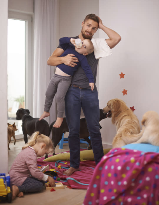 Yes, we need to see more images of stay-at-home dads, but male caregivers are often portrayed as bumbling Mr. Moms on the verge of burning the house down. Take this extremely handsome father needlessly carrying an older child (who has definitely outgrown that burp cloth and bottle), instead of tending to the five — yes, five — dogs in his home.  