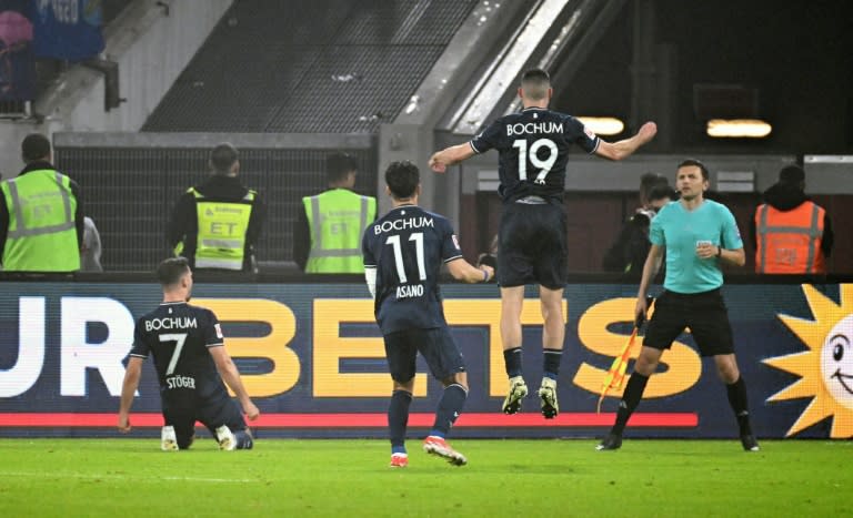 Kevin Stoeger (L) scored one and set up two as Bochum beat Fortuna Duesseldorf on penalties to maintain their place in the Bundesliga (UWE KRAFT)