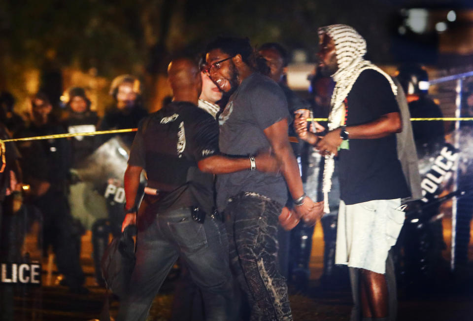 Protesters take to the streets of the Frayser community in anger against the shooting of a youth by U.S. Marshals earlier in the evening, Wednesday, June 12, 2019, in Memphis, Tenn. Dozens of protesters clashed with law enforcement, throwing stones and tree limbs until authorities broke up the angry crowd with tear gas. (Mark Weber/Daily Memphian via AP)