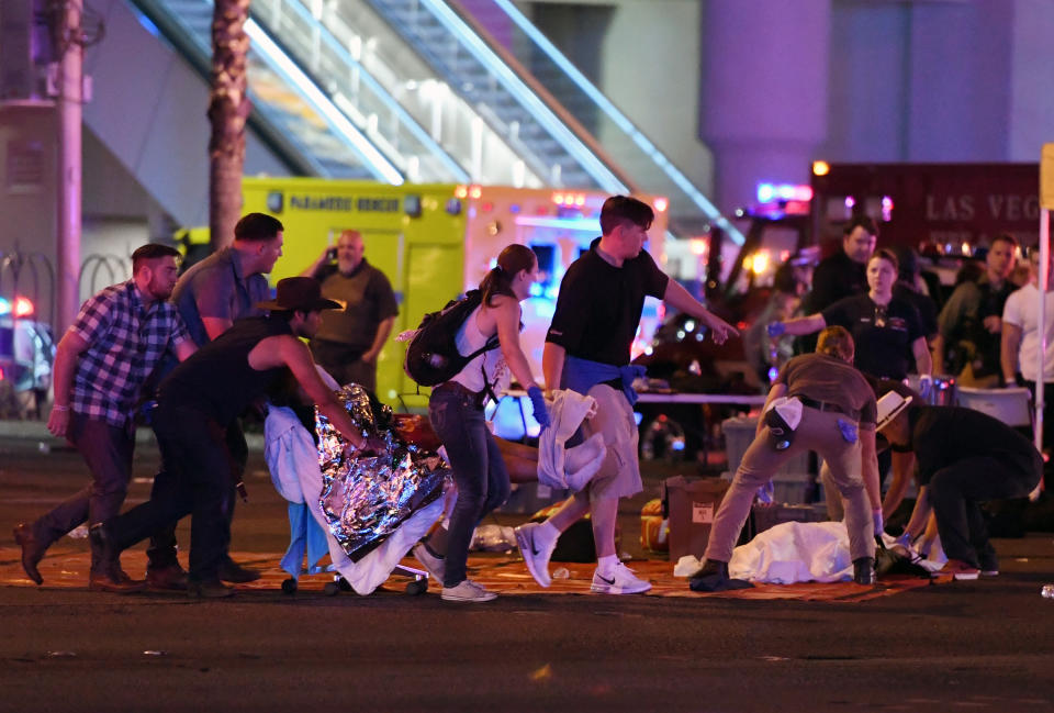 <p>An injured person is tended to in the intersection of Tropicana Ave. and Las Vegas Boulevard after a mass shooting at a country music festival nearby on Oct. 2, 2017 in Las Vegas, Nevada. (Photo: David Becker/Getty Images) </p>