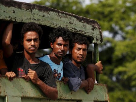 Rohinyga and Bangladeshi refugees are transported to a navy boat where they will be taken to mainland Malaysia, after they landed at Pantai Pasir Berdengung beach in Langkawi island, in the northern state of Kedah, Malaysia, May 14, 2015. REUTERS/Olivia Harris