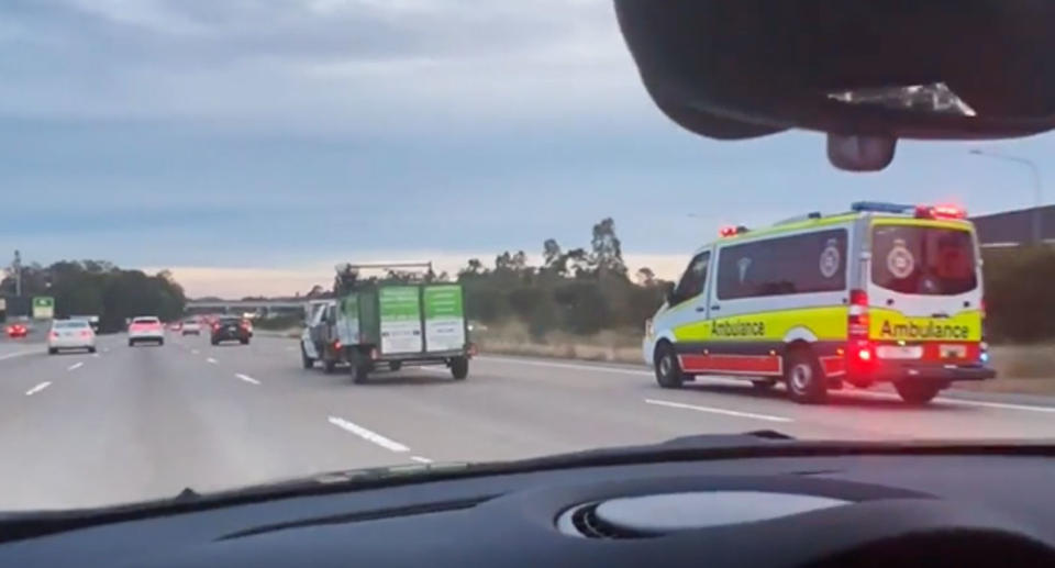 Ute and ambulance on M1 Queensland highway. 