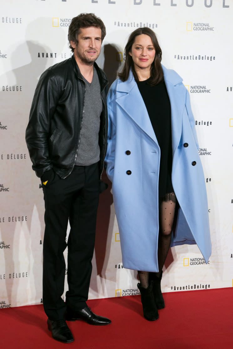 On the red carpet, Marion Cotillard wore an oversize blue Dior coat. (Photo: Getty Images)