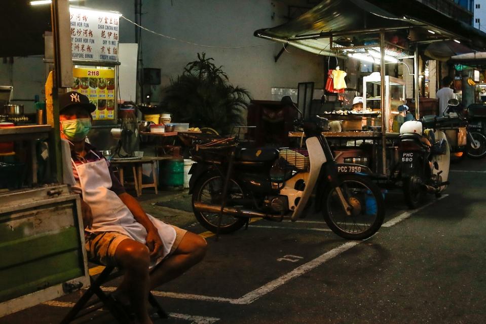 A food stall operator waits for customers at the New Lane Street Foodstalls hawker centre during the conditional movement control order in George Town.