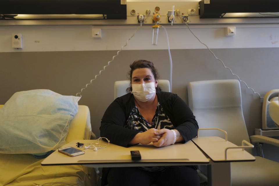 Lolita Andela who works as a carer for a disabled man sits in her hospital room on the eve of her surgery at Bichat Hospital, AP-HP, in Paris Tuesday, Dec. 1, 2020. Hospitals are increasingly grappling with giant backlogs of surgeries that were postponed when COVID-19 hit. To prevent the collapse of their public health systems, countries hard-hit by the virus in Europe prioritized virus patients and put off nonessential procedures, and even some essential ones. (AP Photo/Francois Mori)